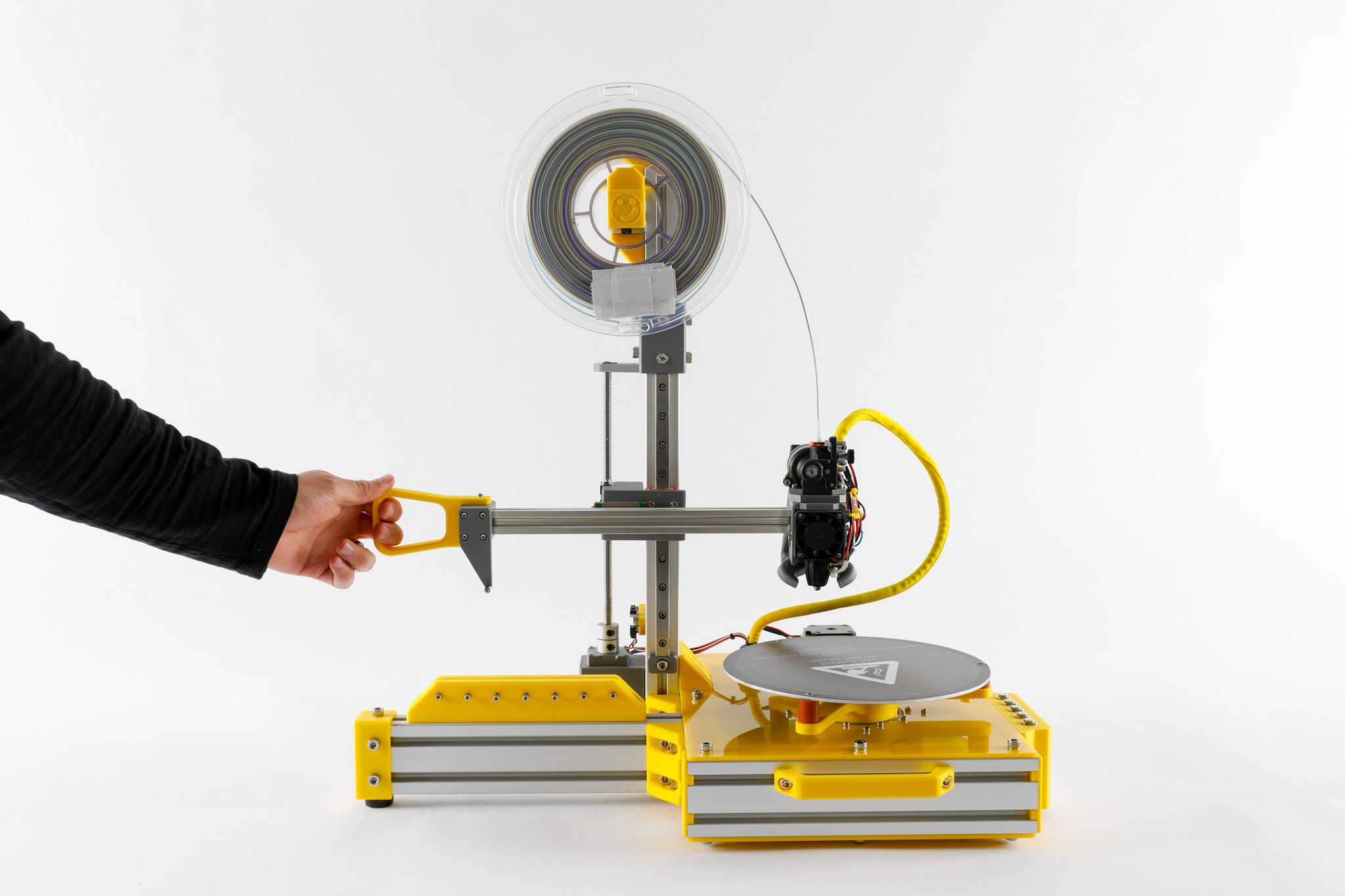 FullCTRL — a hand-driven 3D printer with a yellow handle, guided by hand